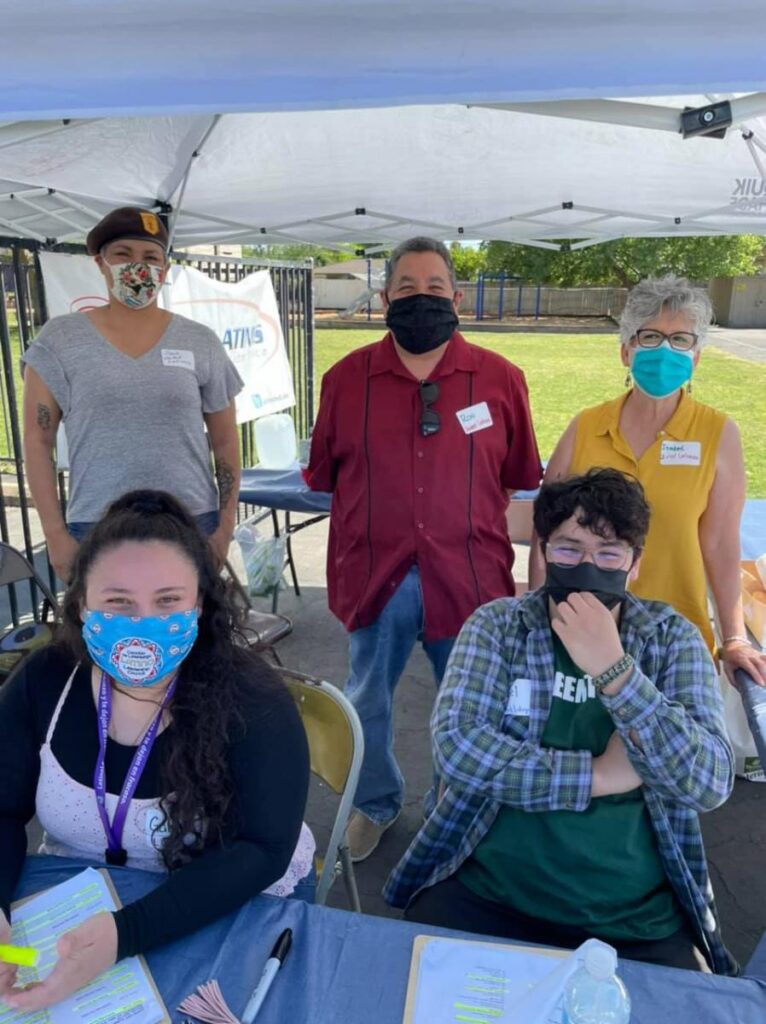 Five United Latinos volunteers at a COVID outreach event.