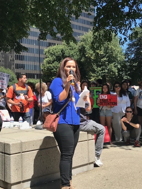 A speaker at an "end family detention" event